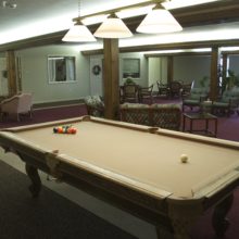 Pool table in the game room. Senior entertainment and fun things to do.